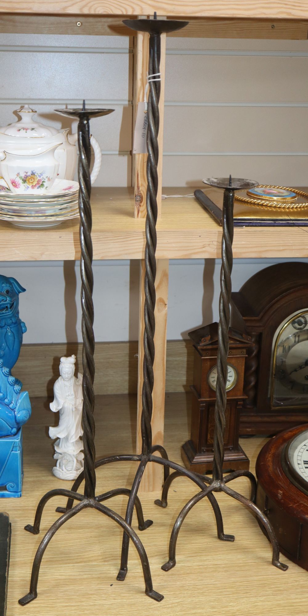 Three wrought iron stem pricket candlesticks, tallest 77cm